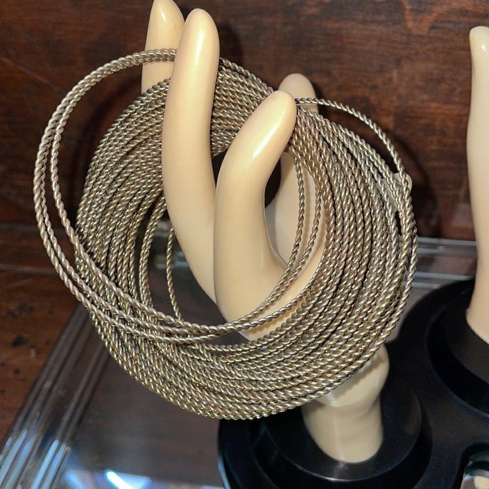Gold tone bangle bracelet with‎ interwoven twisted thin wires